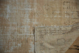 Back of a vintage distressed Oushak rug, revealing its hand-knotted beige foundation and worn pile.