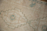 Distressed Oushak rug detail: softened geometric pattern in ivory, beige, seafoam green, even wear.