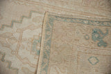 Distressed Oushak runner pile, showing faint foundation and woven reverse side.