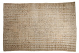Distressed Turkish Oushak carpet, ivory scalloped medallion, faded floral vines, and soft beige tones.