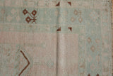 Distressed vintage Melas rug showing soft, even wear and faded blush and mint patterns.