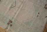Close-up of vintage distressed Melas rug showing even wear and blush, mint geometric patterns.