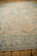 Worn texture of distressed Oushak rug, showing exposed knot heads, ivory, and denim blue.