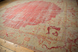Vintage Oushak carpet, ivory Samovar floral border, and cherry red field with soft wear.
