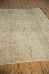 Distressed Oushak rug's worn pile featuring faded agricultural panels in time-softened tones.