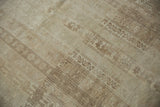 Textured detail of a distressed vintage Oushak rug, revealing aged agricultural motifs and soft beige tones.