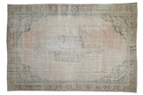 Vintage distressed Oushak carpet, ivory field, faded green medallion, pale chestnut border.