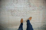 Vintage distressed Oushak carpet texture, faded ivory, pale chestnut, and deep ocean green motifs.