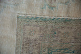 Close-up of vintage distressed Oushak rug back foundation and pile edge with fringe.