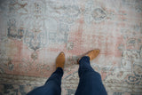 Distressed vintage Sparta carpet with faded blush, silver blue, and worn texture.
