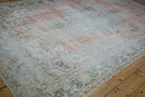 Distressed vintage Sparta carpet with faded blush, silver blue, and low pile texture.