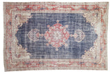 Vintage Distressed Sparta Carpet with navy field, brick red medallion, and stylized dragon border motifs, 8'1