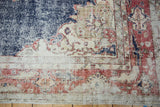 Distressed navy field and brick red border with stylized motifs on a vintage Sparta rug.
