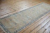 Distressed vintage Sparta runner with antique ivory field, cobalt blue floral palmettes, and visible foundation.