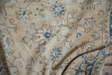 Worn ivory and cobalt blue floral patterns with foundation showing through distressed pile.