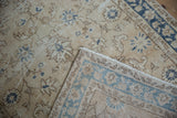Distressed Sparta runner with worn ivory and blue floral pile, revealing hand knotted foundation.
