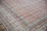 Decorative distressed vintage Sparta carpet pile, highlighting muted rust, indigo, and ivory boteh motifs.
