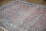 Distressed vintage Sparta carpet showing faded pale rust, indigo boteh, and border details.