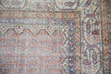 Distressed vintage Sparta carpet with textured pile, showing pale rust, indigo, and ivory boteh designs.