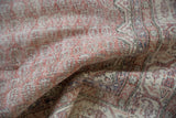 Distressed texture of the Sparta carpet pile, with pale rust, ivory, and subtle indigo tones.