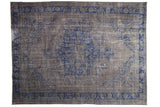 Vintage distressed Oushak rug with a cobalt blue medallion on a weathered silver and charcoal field.
