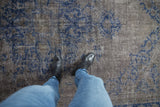 Worn, low-pile texture of a distressed Oushak rug in charcoal, silver, and overdyed cobalt blue.