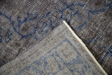 Corner detail of the hand-knotted back and distressed silver and blue pile.