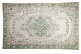 Distressed vintage Oushak, ivory and faded green Rococo medallion, sprawling vinery, 6'1