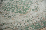 Distressed green, ivory, pale coffee Oushak vinery with visible foundation wear.
