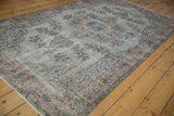 Overdyed distressed vintage Oushak rug detail with muted floral pattern and visible foundation.