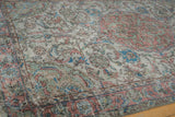 Distressed vintage Oushak carpet with worn knot heads, floral vinery, dusty terracotta border.