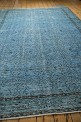 Distressed pale denim blue pile texture and secured selvage edge of a vintage Oushak rug.