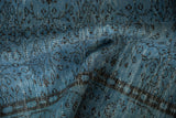 Distressed texture of vintage Oushak rug, highlighting pale denim blue and dark vinery.