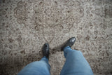 Vintage Distressed Oushak carpet texture with Rococo vinery, silver, and chocolate brown.