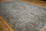 Distressed Oushak carpet featuring silver, oxidized silver, and chocolate brown Rococo vinery.