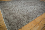 Curvilinear vinery in silver and chocolate brown on the distressed vintage Oushak carpet.