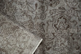 Distressed Oushak carpet pile detail: faded silver, chocolate brown Rococo pattern, hand-knotted back.
