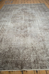 Distressed vintage Oushak carpet with worn pile texture and oxidized silver tones.