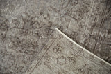Distressed vintage Oushak rug pile in oxidized silver and chocolate, showing hand-knotted foundation.
