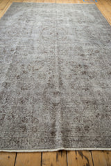 Distressed Oushak carpet pile, mostly even wear, oxidized silver, chocolate tones, fringe.