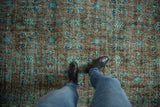 Distressed overdyed Oushak rug showing worn pile, faint foundation, terracotta, sea foam, blue floral palmette vinery.