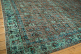 Distressed overdyed Oushak carpet showing faded sea foam, blue floral vines, and foundation.