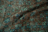 Distressed Oushak rug with even wear, featuring terracotta and sea foam green floral vinery.