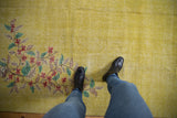 Distressed yellow Turkish Oushak carpet showing foundation through faded red, green flora.