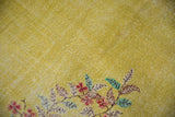 Distressed yellow field showing wear to foundation and red, green floral vinery.