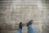 Vintage distressed Oushak carpet, silver and oxidized patterns, worn pile, visible foundation, with feet.