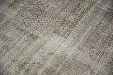 Distressed vintage Oushak rug showing muted silver pile with oxidized tones and exposed foundation.