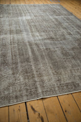 Intact side cord selvage and worn silver tones of the distressed vintage Oushak rug.