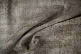 Distressed vintage Oushak carpet with areas of wear revealing oxidized silver foundation.