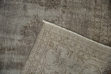 Distressed silver Oushak pile texture revealing wear and hand-knotted foundation.